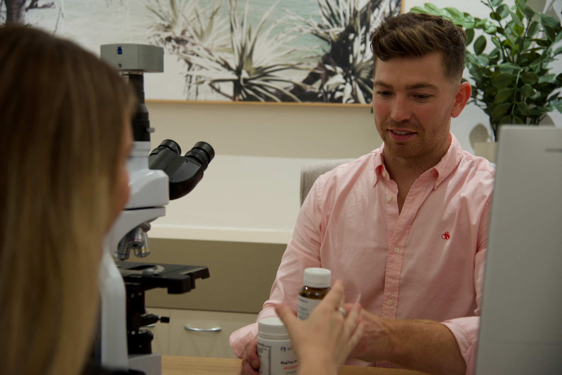 Naturopath discussing treatment options with patient in a modern clinic
