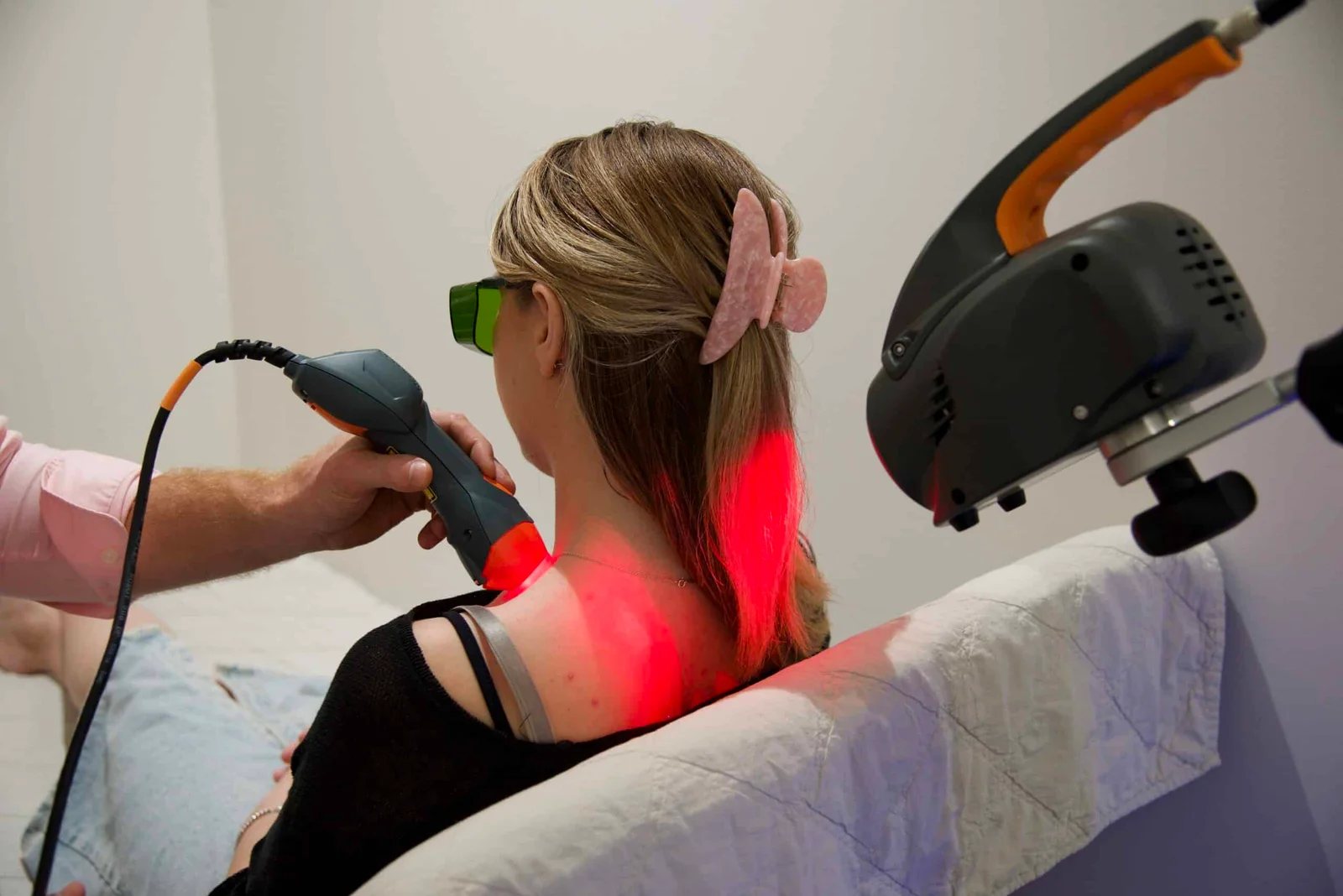 Naturopath doing MLS laser treatment for female patient at NXTLVL Health