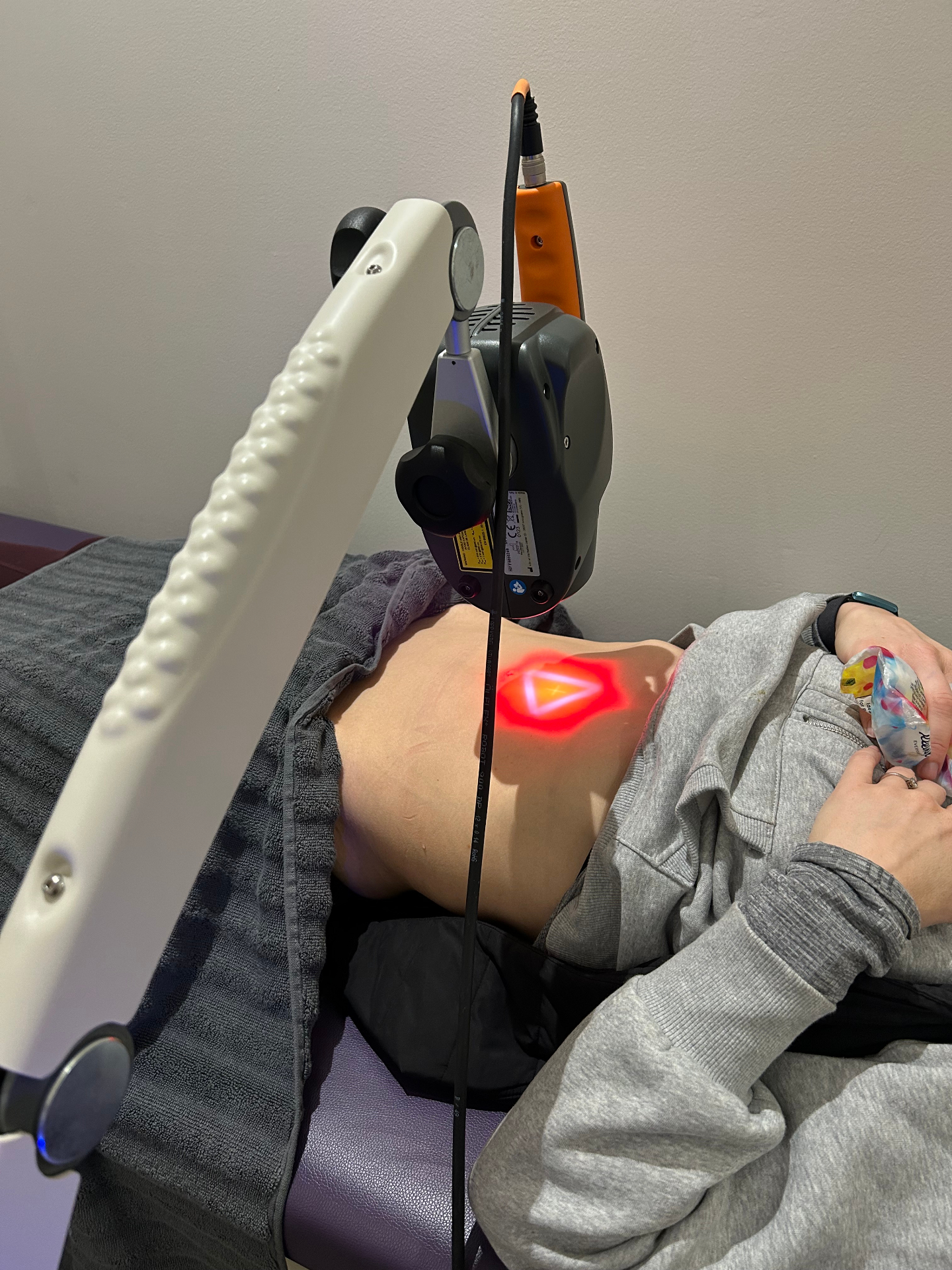 MLS laser therapy treatment targeting abdominal area for pain relief