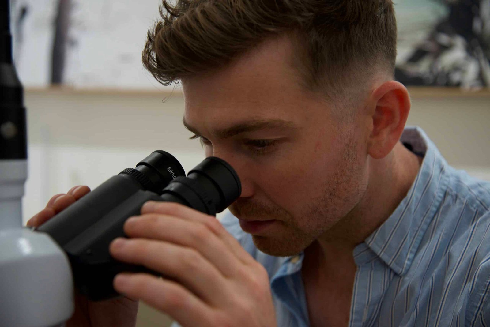 Naturopath looking through microscope